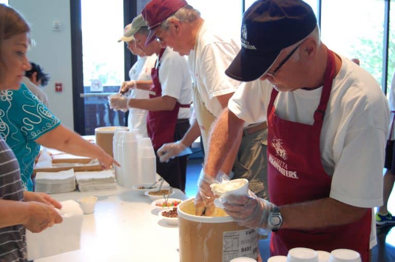 Scooping ice cream at the Wichita Art Museum's Summer Birthday Bash