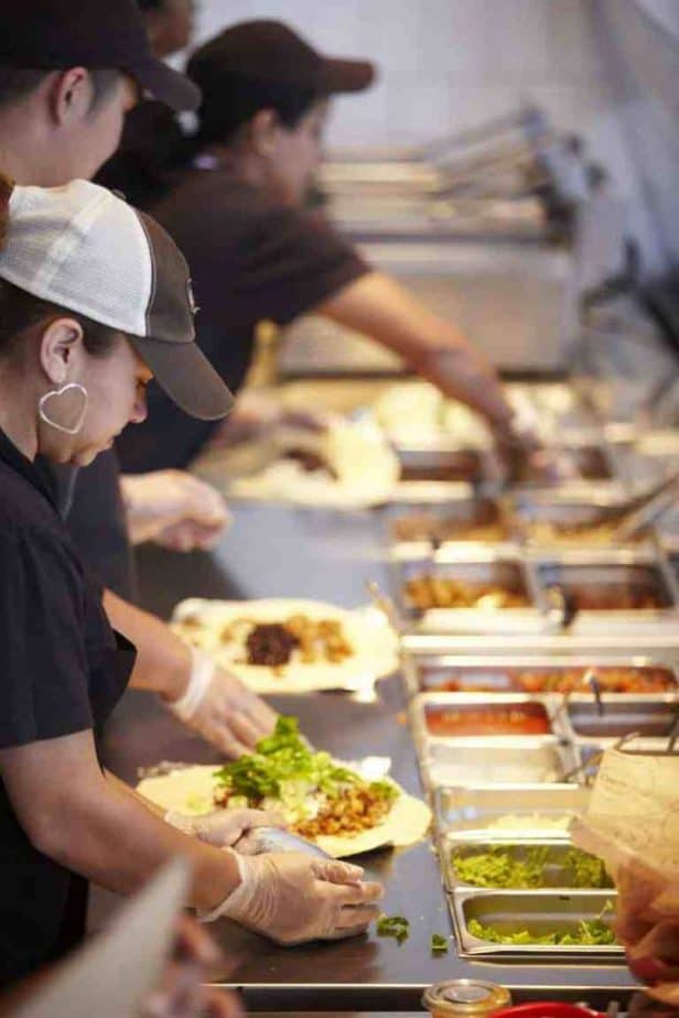 Chipotle workers preparing food