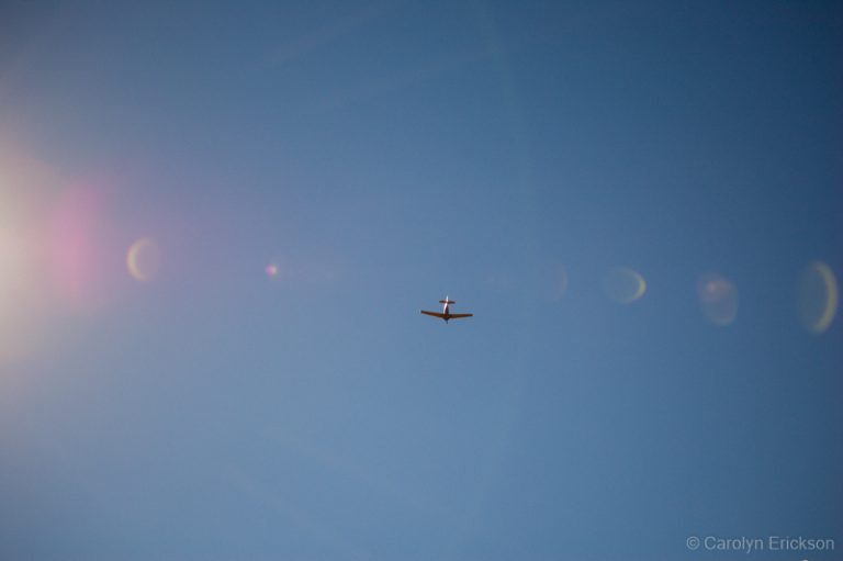 airplane flying in the sunlight