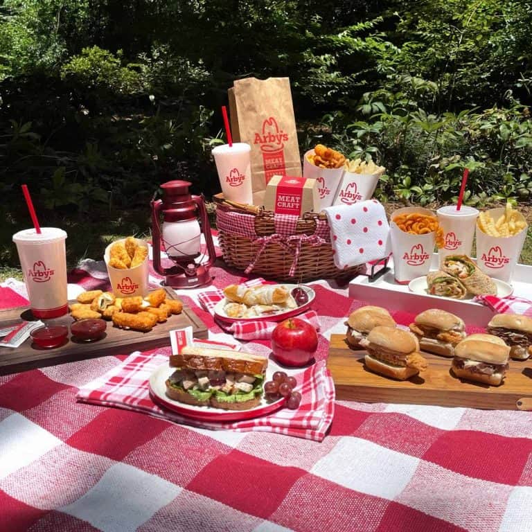 Picnic layout with Arby's 2 for $6 value meal included among the other food