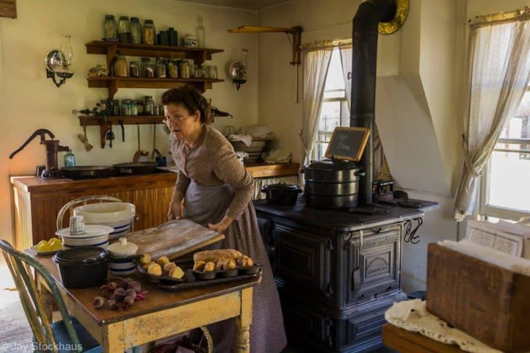 Prairie woman baking in kitchen at historic Old Cowtown Museum - photo by Jay Stockhause